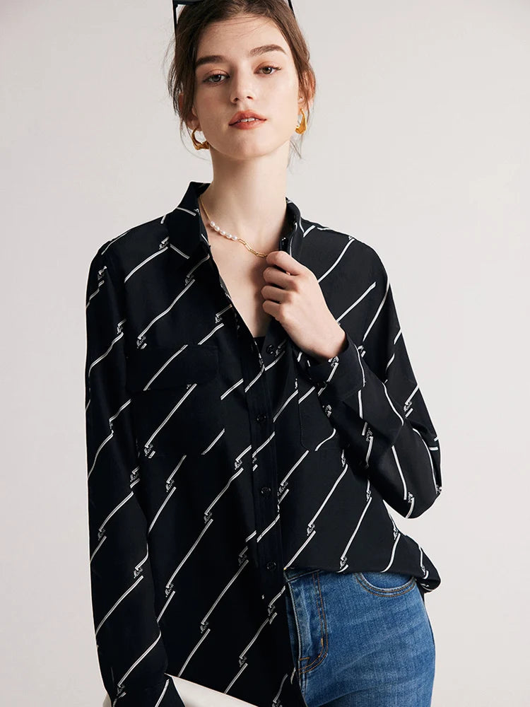 Model highlighting the collar of Women's Mulberry Silk Shirt with Black and White Diagonal Stripes by touching it. From Borcelleclothes.