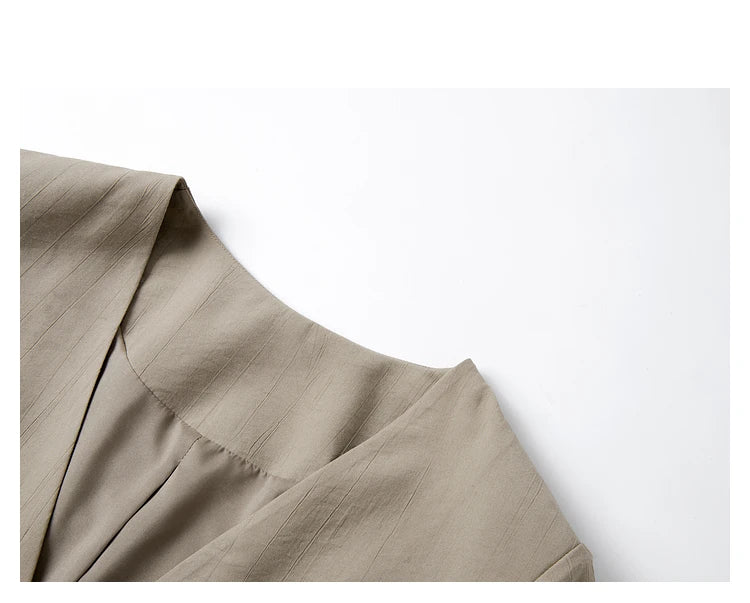 Detailed view of the jacket’s V-neckline and short sleeves in the Olive Haze two-piece set. From Borcelleclothes.