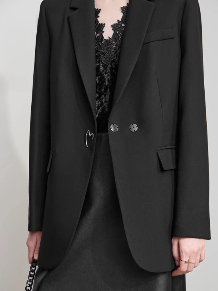 Model wearing Onyx minimal blazer, view of middle and bottom sections with long clean silhouette – From Borcelleclothes.