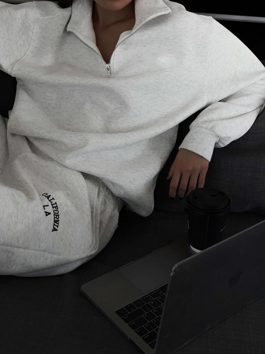 Women's Oversized Single-Sided Fleece Sweatshirt in Silver. Cozy and stylish with a zippered high-neck, relaxed fit, drop shoulders, and an elastic waistband. Made from a durable blend of cotton and polyester for softness and longevity, perfect for casual outings or lounging. From Borcelleclothes.