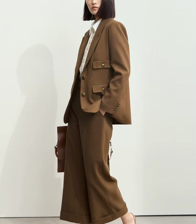 Model in Irish Coffee blazer walking with a slight turn to the side, capturing the natural rhythm of movement in a poised silhouette. From Borcelleclothes.