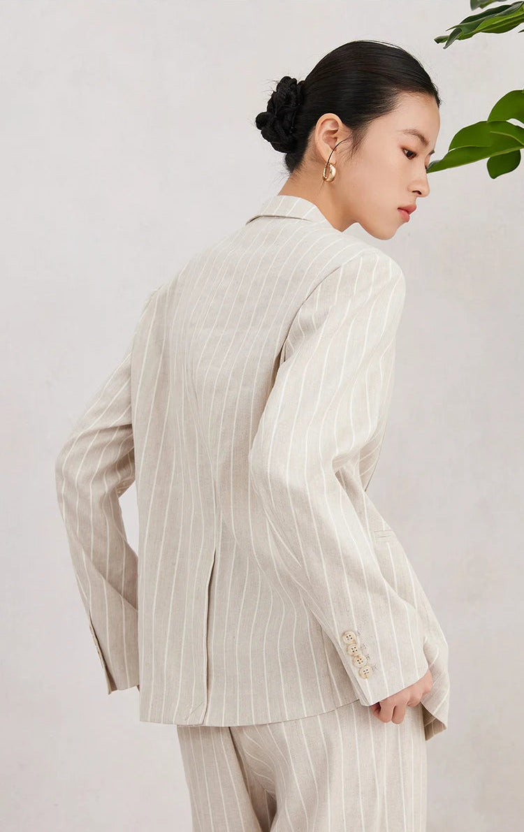 Back view of the Pearl Bush striped blazer showing clean seams and central vent on model. From Borcelleclothes.