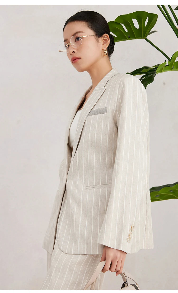 Side profile of the Pearl Bush striped blazer on model, showing peaked lapels and soft tailoring lines. From Borcelleclothes.
