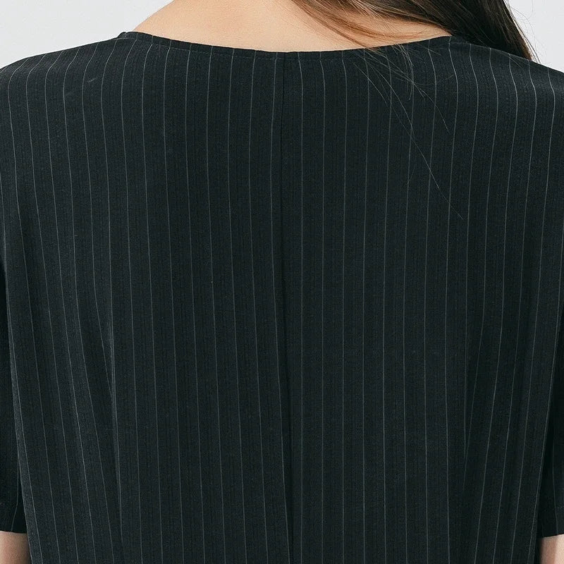 Back upper part of the dress featuring tailored structure and subtle pinstripe texture in Jaguar-hued silk. From Borcelleclothes.