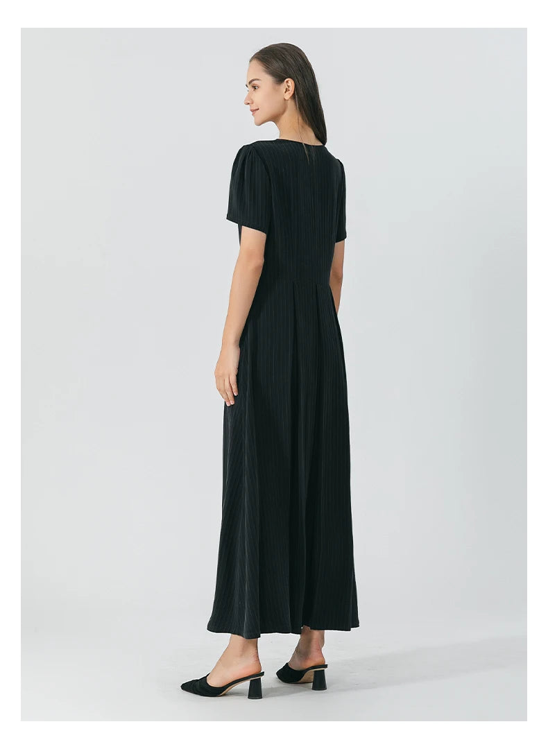 Full back view of the dress revealing the structured pleats, maxi length, and soft sheen of Jaguar-colored silk. From Borcelleclothes.