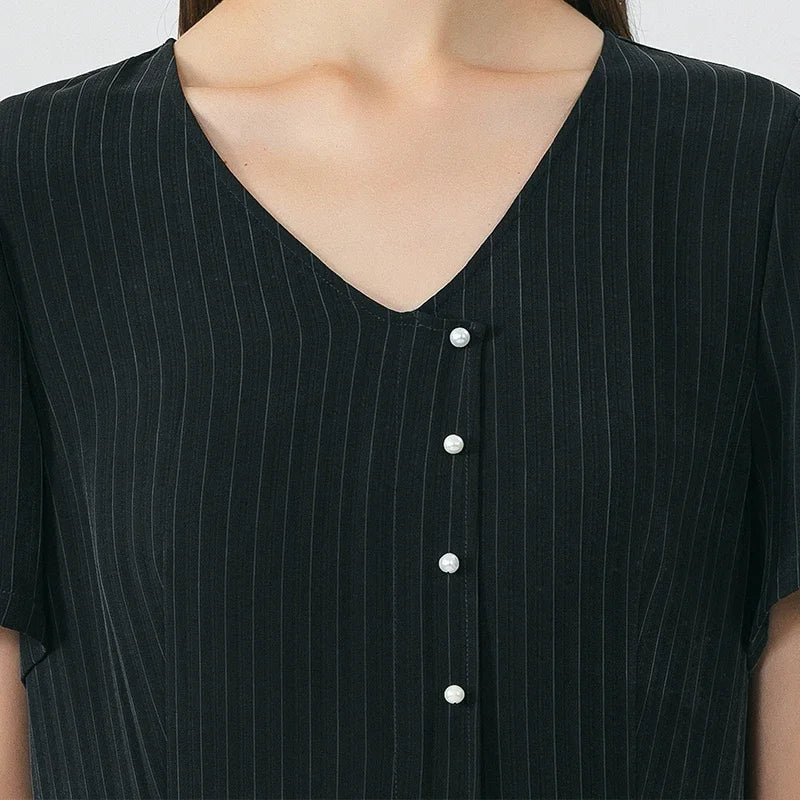 Front upper view of the wrap dress highlighting the V-neckline and pearl-like buttons in Jaguar pinstripe silk. From Borcelleclothes.