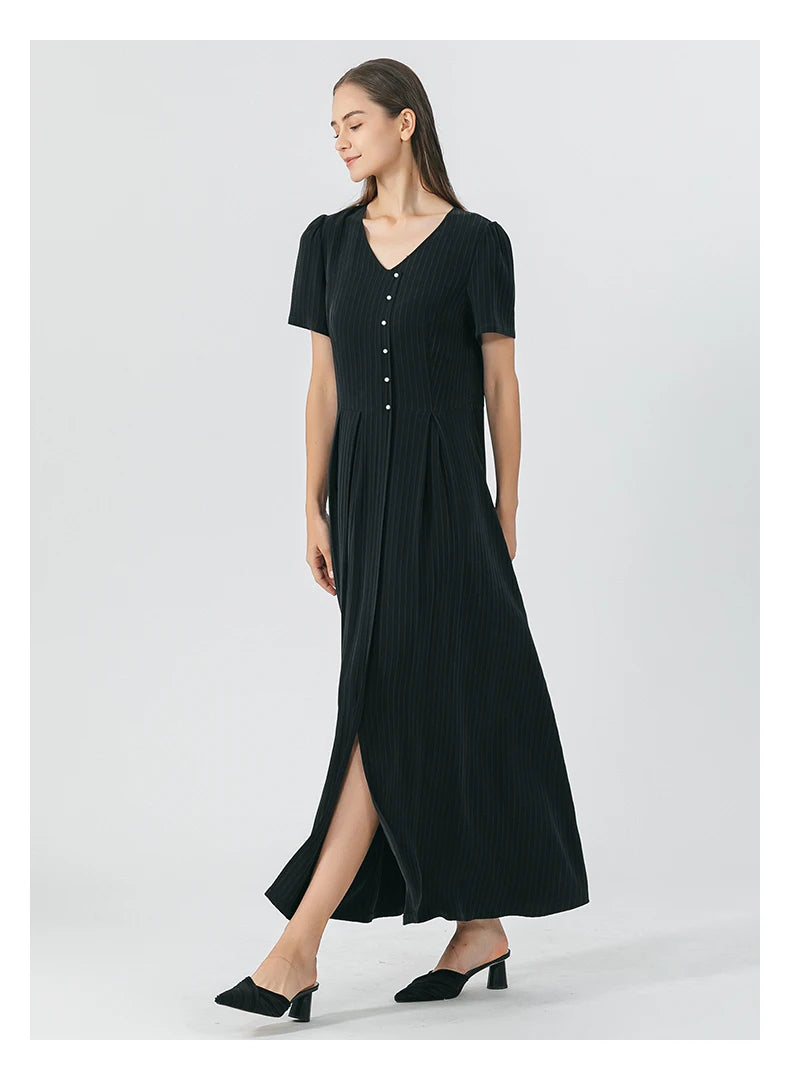 Model reveals the flared bottom construction of the pinstripe silk wrap dress in Jaguar color, showcasing the skirt’s overlap and drape. From Borcelleclothes.