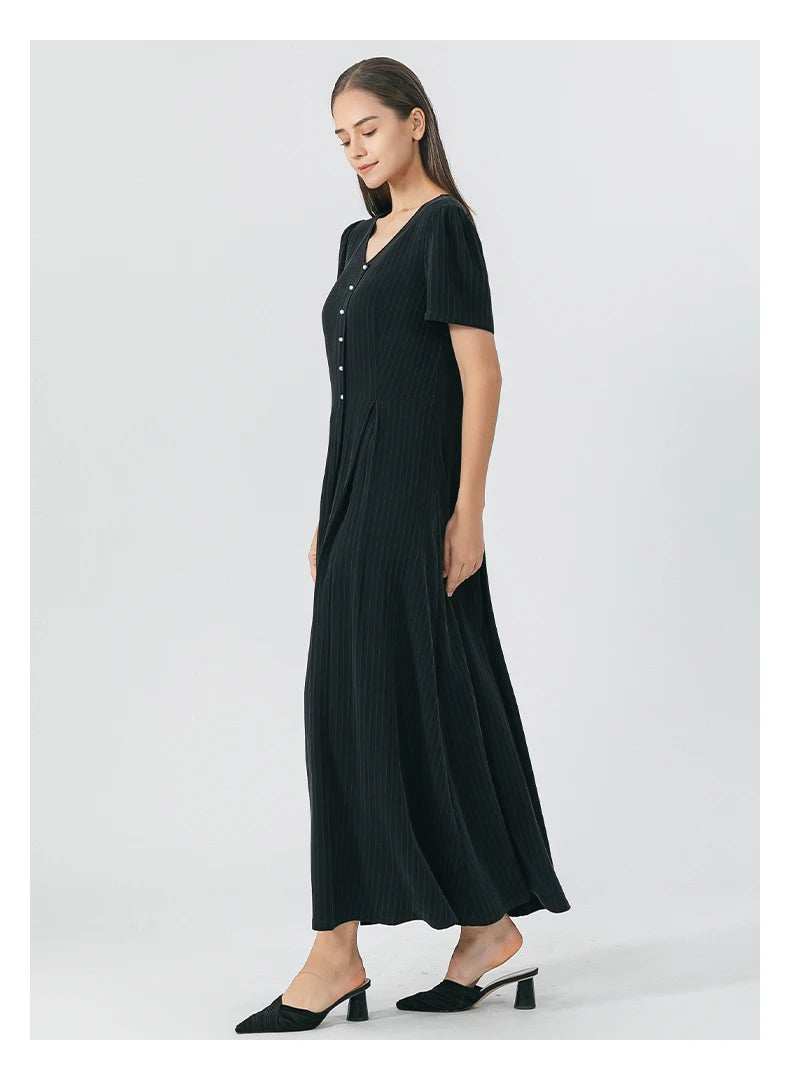 Side profile of the wrap dress showing the flared silhouette and layered drape in rich pinstripe silk. From Borcelleclothes.