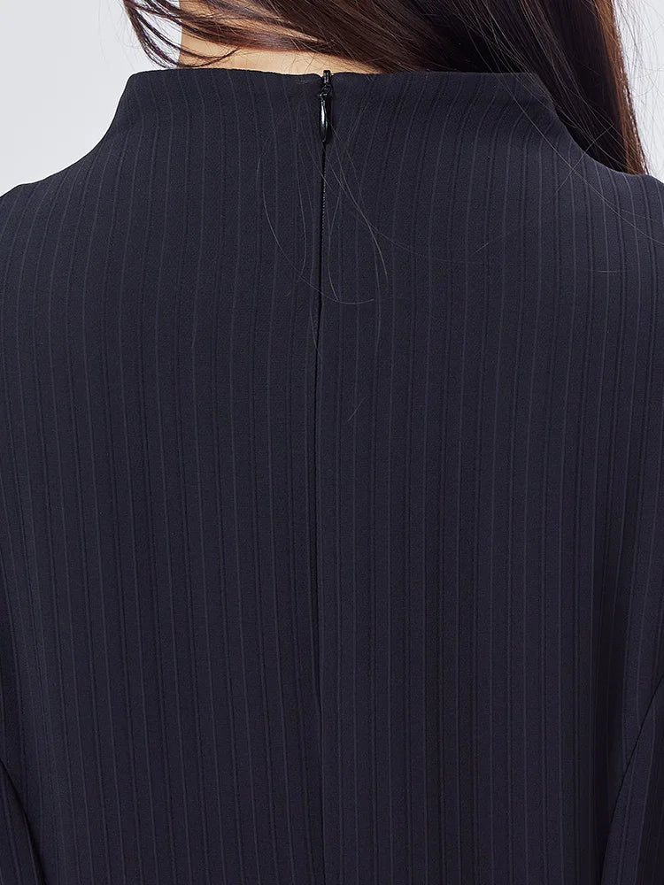 Back view of the high neckline and smooth upper structure in Black Pearl silk jacquard with fine vertical lines. From Borcelleclothes.