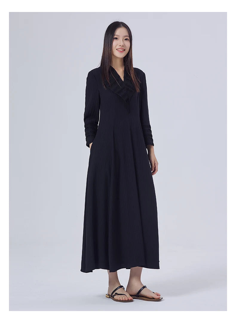 Model resting her hand in the hidden side pocket, showing the fluid transition from tailored top to flared skirt. From Borcelleclothes.