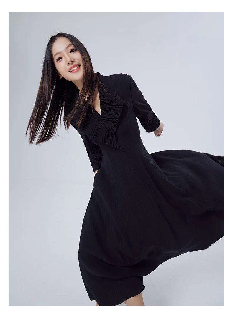 Model in motion wearing the Black Pearl pinstriped silk jacquard dress, hem lifting gently with movement. From Borcelleclothes.