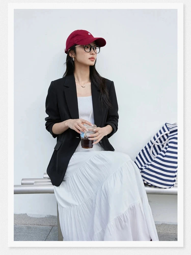 Woman in Onyx Urban Blazer sitting on a bench. From Borcelleclothes.