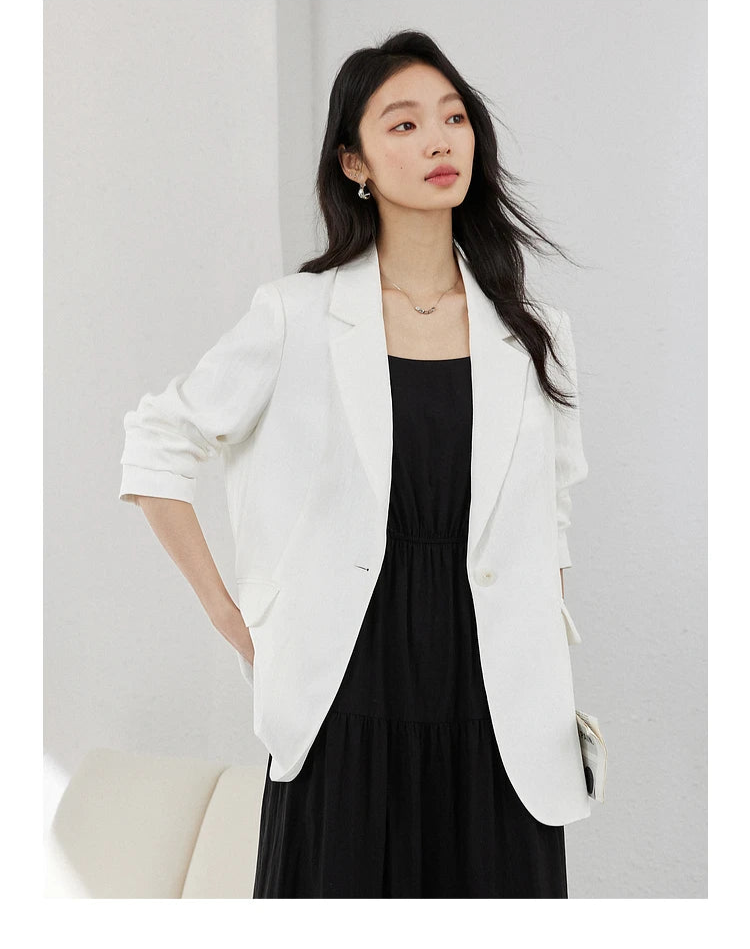 Woman in Platinum Urban Blazer with one hand behind her back. From Borcelleclothes.