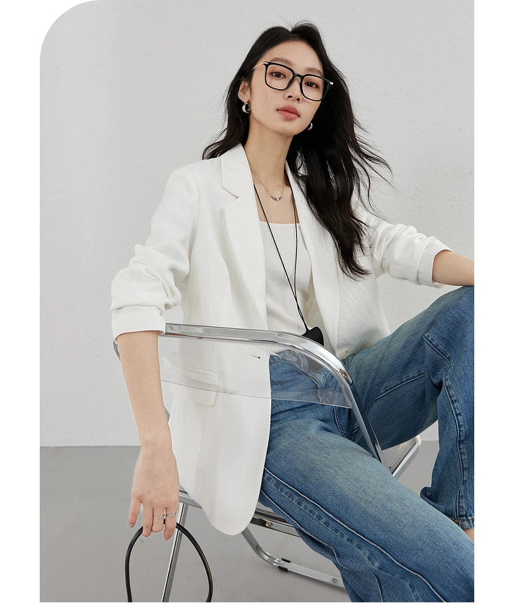 Woman in Platinum Urban Blazer sitting on a chair. From Borcelleclothes.