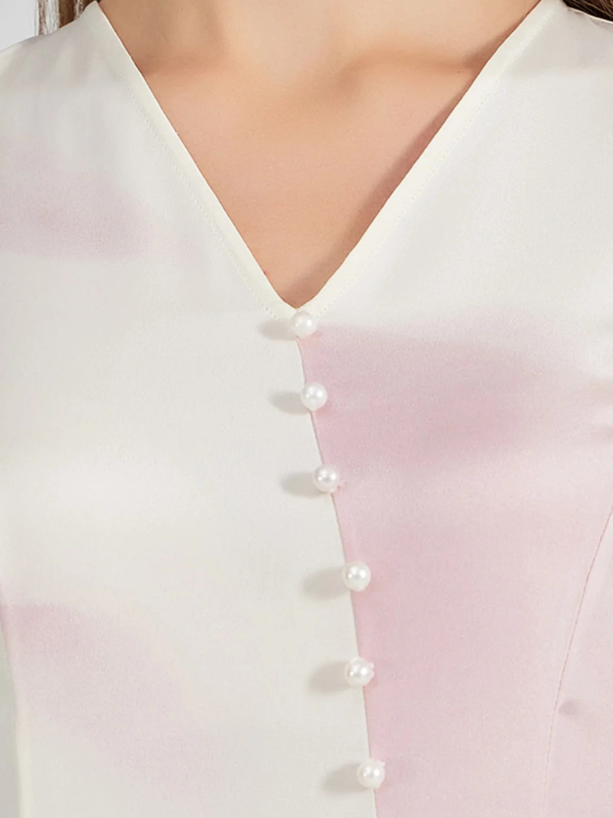 Front view of the upper part of the silk dress, featuring the V-neckline and pearl-like buttons. From Borcelleclothes.