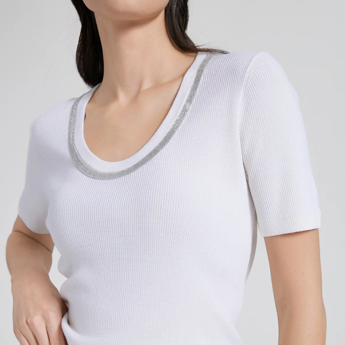 Close-up of woman wearing White Lilac Merino wool and silk top, showing the soft oval neckline with rhinestone fringe. From Borcelleclothes.