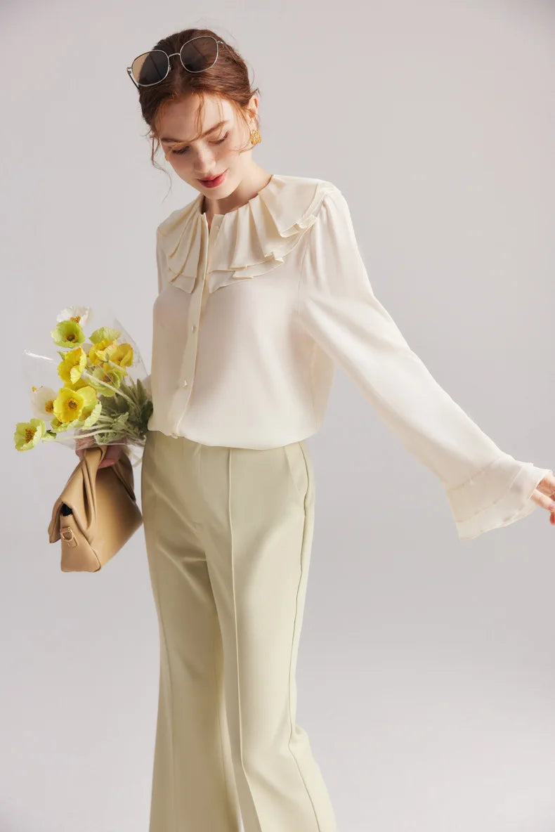 Model wearing the Women's Romantic Pearl Bush Silk Blouse stretched the arm side, showcasing the double-layered flounce cuffs in luxurious 6A Grade Mulberry Silk. From Borcelleclothes.