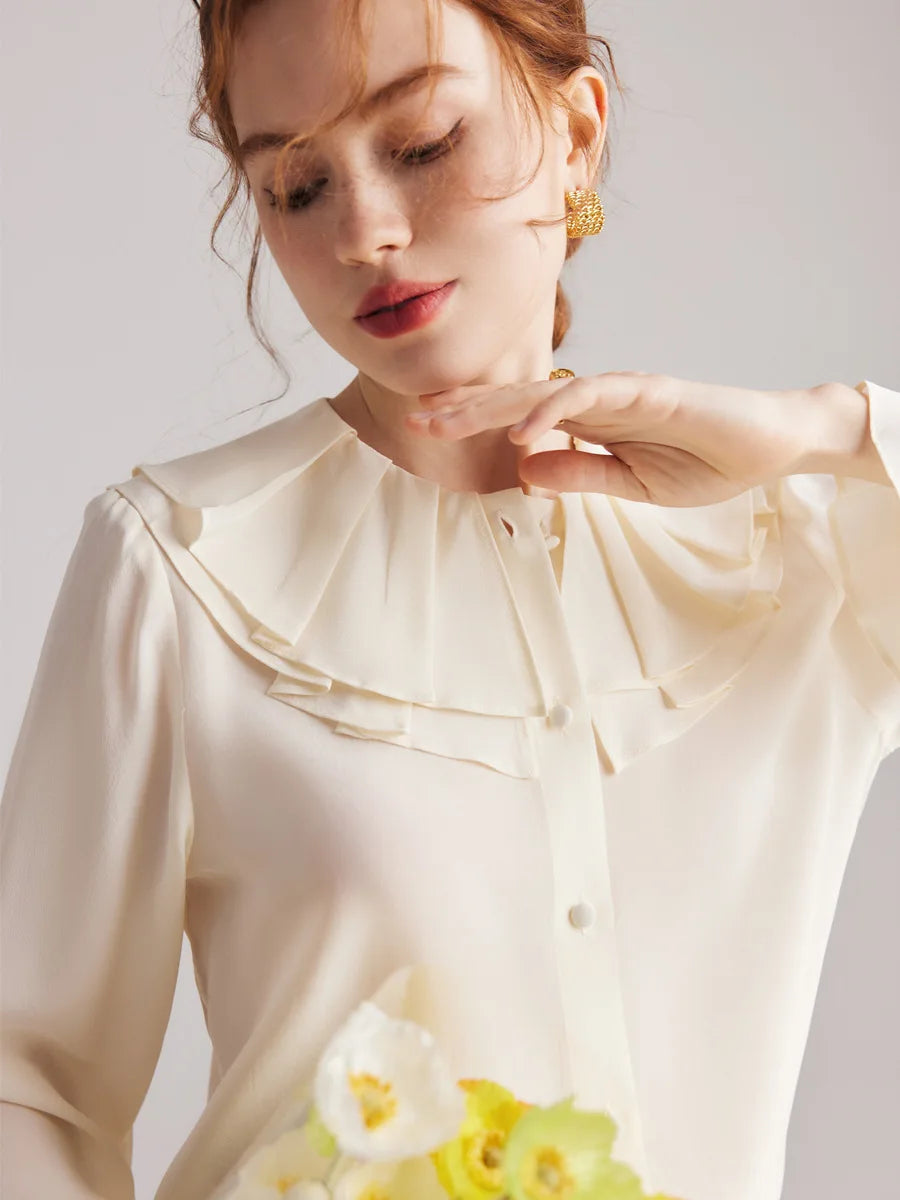 Model wearing the Women's Romantic Pearl Bush Silk Blouse, gently touching her chin to showcase the vintage-inspired double pilgrim collar. From Borcelleclothes.
