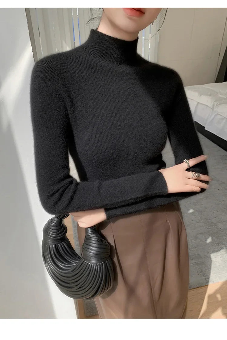 A model wearing the women's Saddle Sleeves Cashmere Sweater in Dark Grey crossed her arms. From Borcelleclothes.