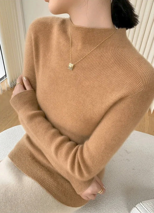 A model wearing the women's Saddle Sleeves Cashmere Sweater in Mocha crossed her arms. From Borcelleclothes.