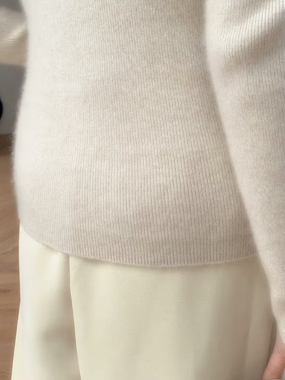 The back bottom part of the women's Saddle Sleeves Cashmere Sweater in Soft Amber, showcasing ribbed details and the smooth cashmere texture, Borcelleclothes.