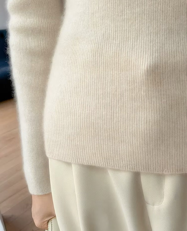 The bottom hem of the women's Saddle Sleeves Cashmere Sweater in Soft Amber, featuring ribbed detailing for a polished finish, Borcelleclothes.