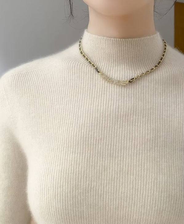 The upper part of the women's Saddle Sleeves Cashmere Sweater in Soft Amber, showcasing the refined mock neck and shoulder line, Borcelleclothes.