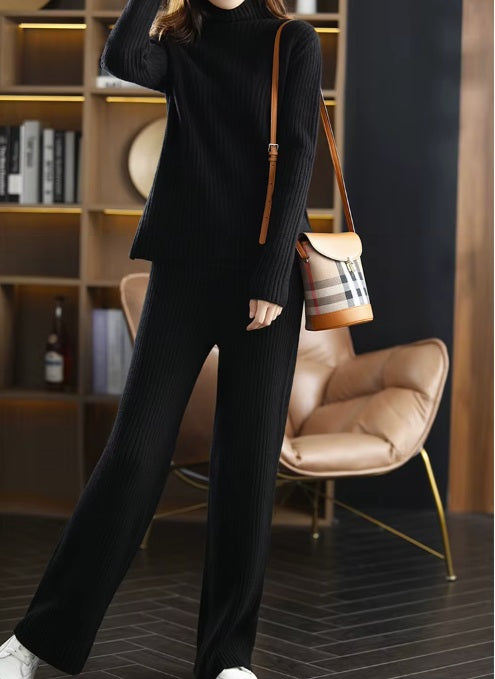 Model wearing the women's Sculpted Wool Set in Onyx, carrying a stylish bag, emphasizing the elegant ribbed design and contemporary look, Borcelleclothes.