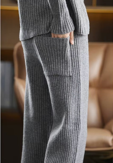 Back of a model wearing the women's Sculpted Wool Set in Oslo Grey, with one hand in the pants pocket, highlighting the ribbed texture and modern design, Borcelleclothes.