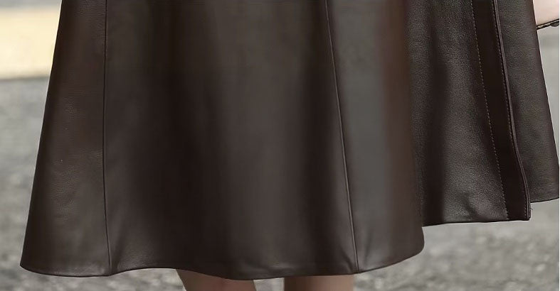 Women's Sheepskin Down Coat in Eclipse. The flared mid-calf hem creates a fluid, sculptural silhouette. Borcelleclothes.