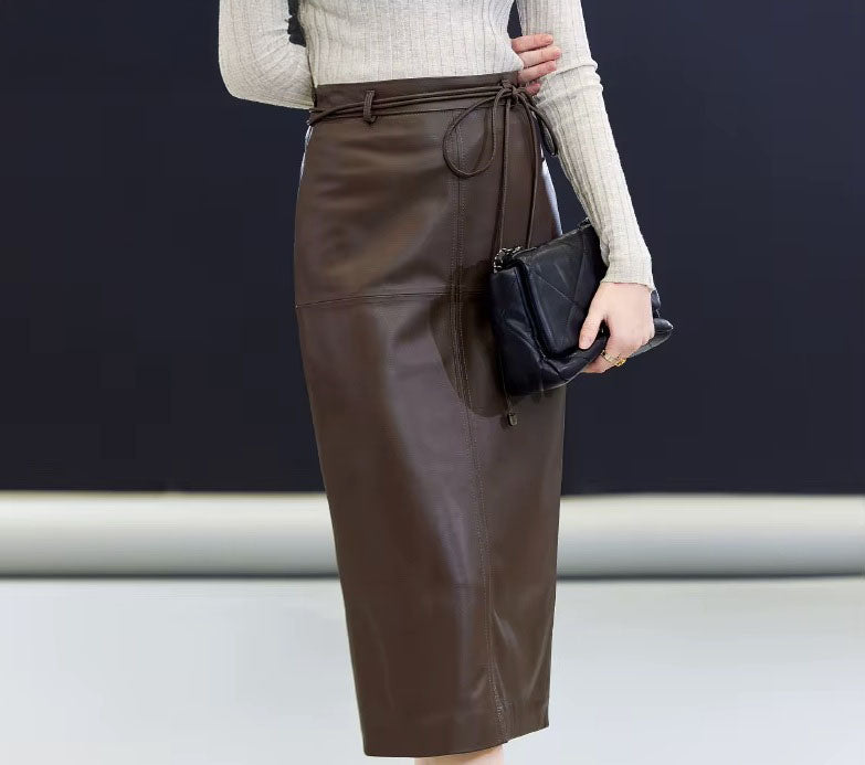 Woman in Dark Rum skirt with bent arm behind — subtle curve echoing the skirt’s balance of form and intention. From Borcelleclothes.