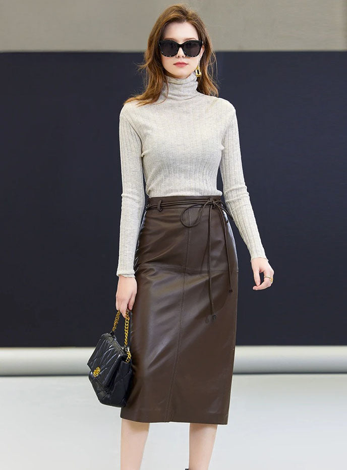 Model wearing the sheepskin midi skirt in Dark Rum with one foot placed to the side — a grounded stance that emphasizes the skirt’s length and composed silhouette. From Borcelleclothes.