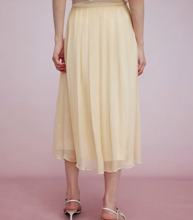 Back view of Apricot White skirt, revealing clean fall and layered texture. From Borcelleclothes.
