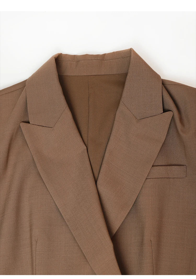 Collar and peaked lapels detail of women’s sheer-sleeved wool blazer in Milk Chocolate. From Borcelleclothes.