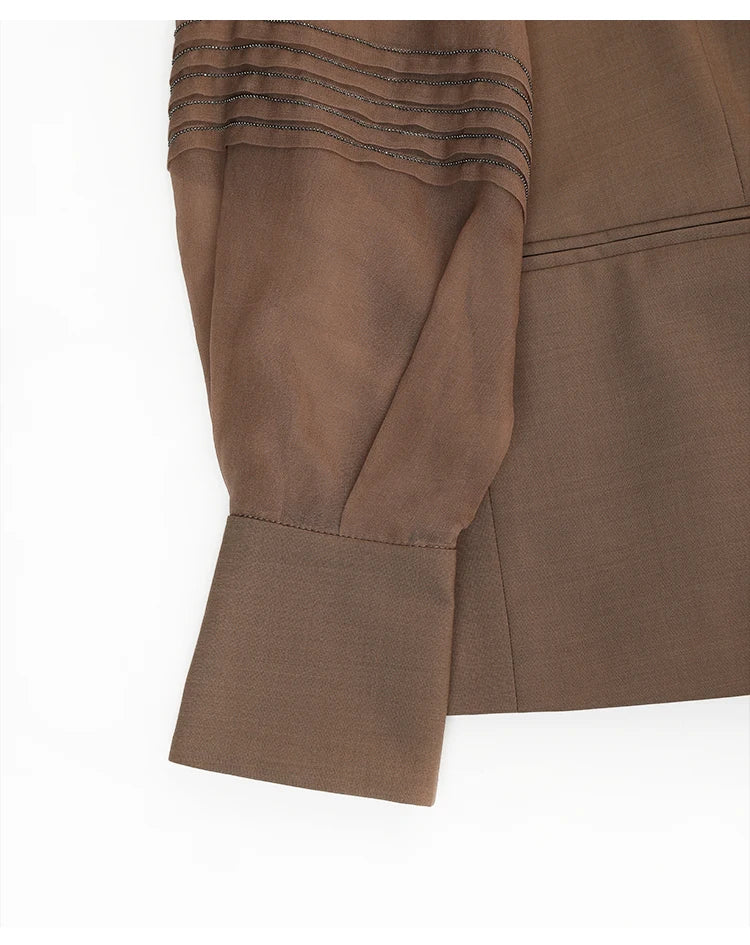 Extended cuff with tonal button and rhinestone chain on women’s sheer-sleeved wool blazer in Milk Chocolate. From Borcelleclothes.