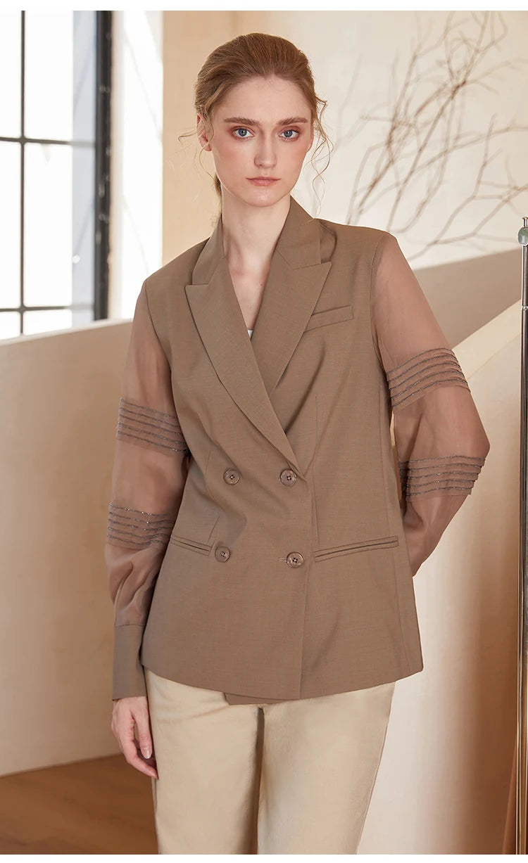 Women’s sheer-sleeved wool blazer in Milk Chocolate, model with hand behind back. From Borcelleclothes.