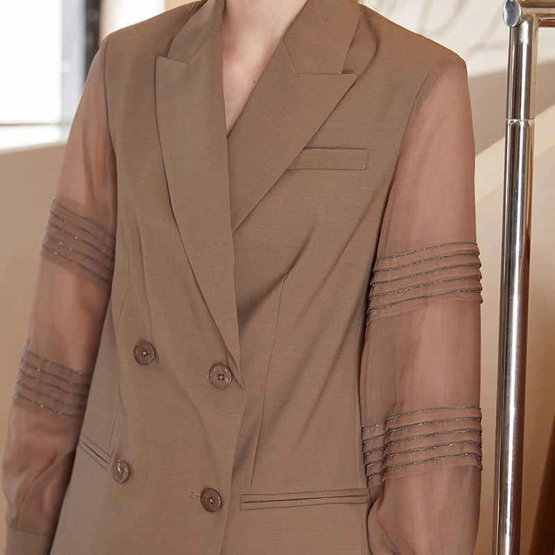 Upper part of women’s sheer-sleeved wool blazer in Milk Chocolate with rhinestone pleats. From Borcelleclothes.