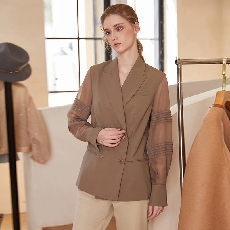 Women’s sheer-sleeved wool blazer in Milk Chocolate with pleated rhinestone chain detail, double-breasted cut, and peaked lapels — rhythm and lightness in balance. From Borcelleclothes.