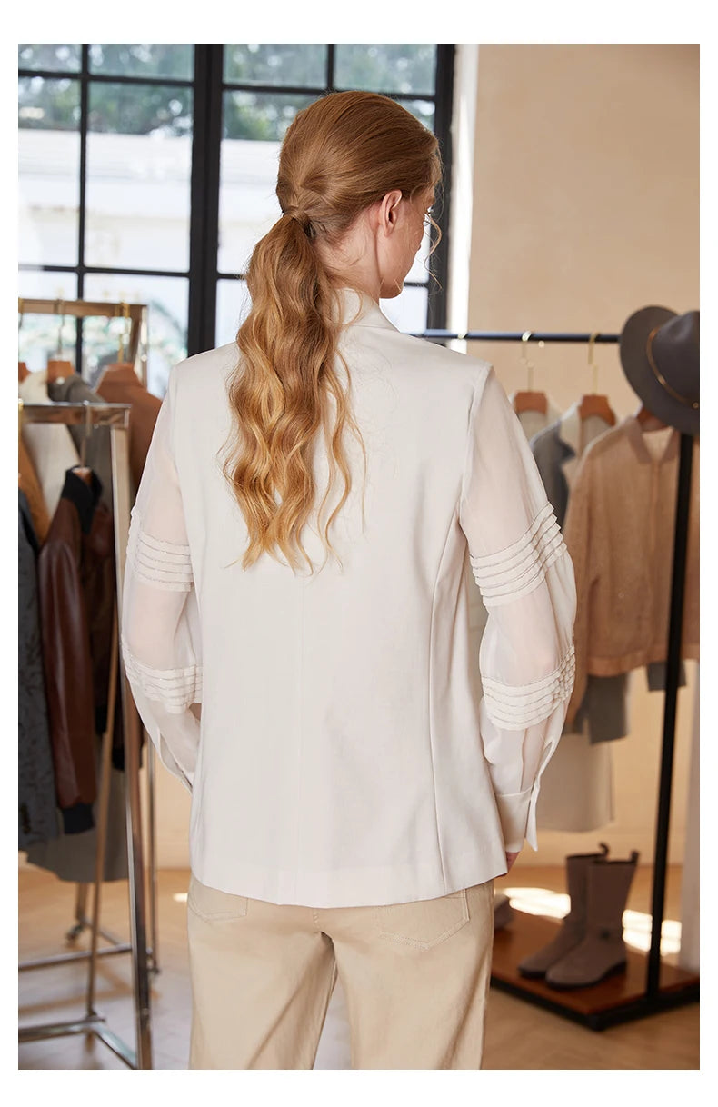 Back view of women’s sheer-sleeved wool blazer in White Coffee with rhinestone sleeve pleats. From Borcelleclothes.