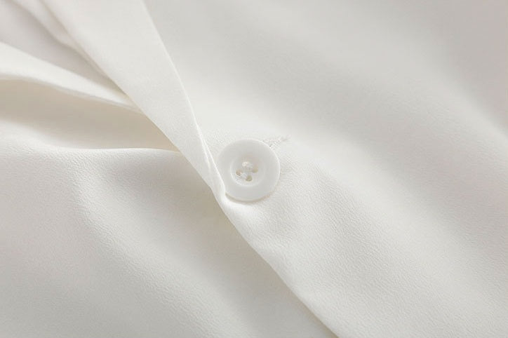 Close-up of the single-button closure on the Romance silk blazer — subtle, discreet, and thoughtfully placed. From Borcelleclothes.