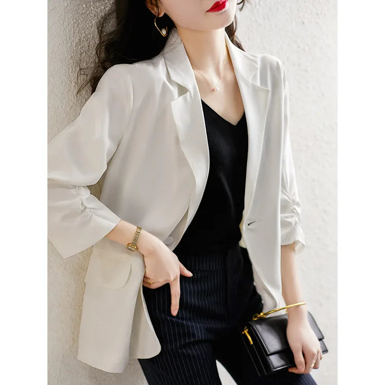 Model in the Romance blazer with one hand in her pant pocket — relaxed presence in a soft, breathable silk layer. From Borcelleclothes.