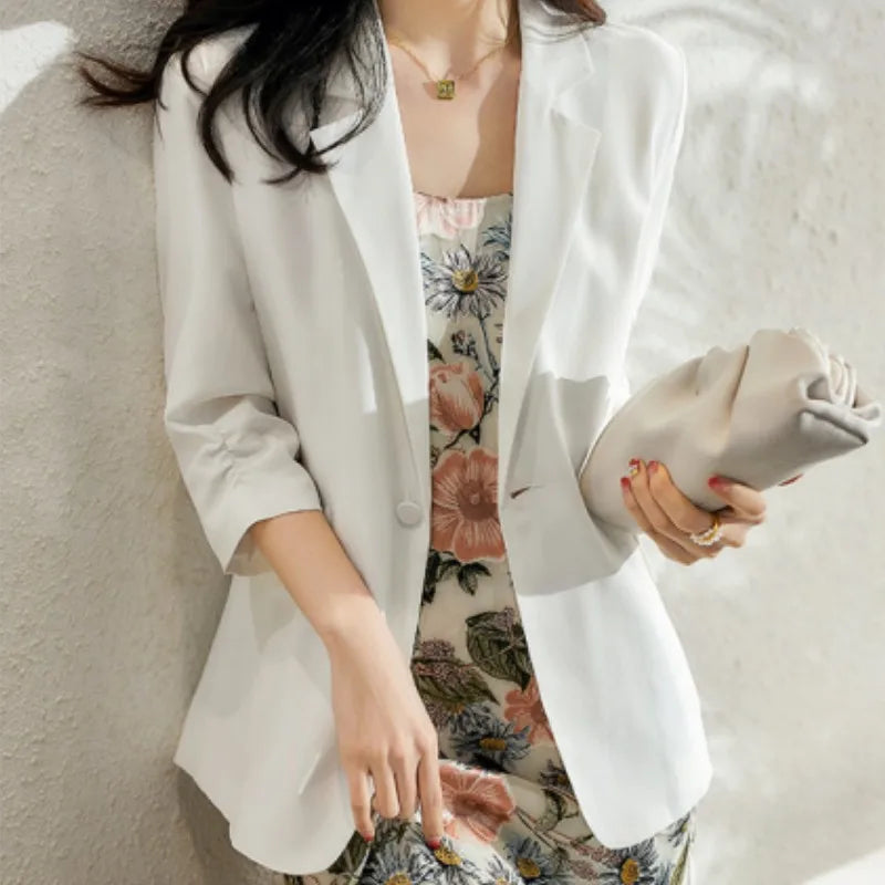 Model in Romance blazer holding a small bag — the lightweight blazer quietly complementing the overall look without drawing focus. From Borcelleclothes.