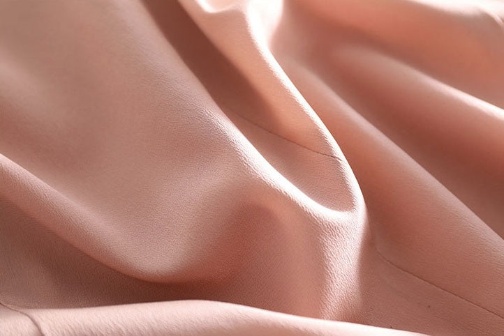 Draped texture of the Rose Fog silk blazer — revealing the fluid, breathable nature of 100% mulberry silk. From Borcelleclothes.