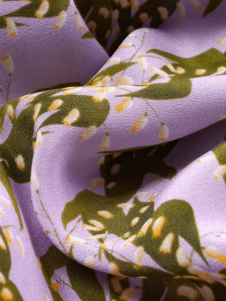 Folded section of pastel floral silk shirt showing texture and light reflection. From Borcelleclothes.
