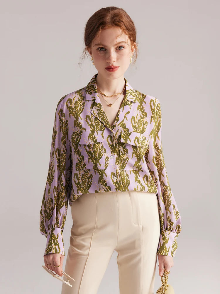 Model looking straight ahead in pastel floral silk shirt, highlighting the shirt’s vivid pattern and notched collar. From Borcelleclothes.