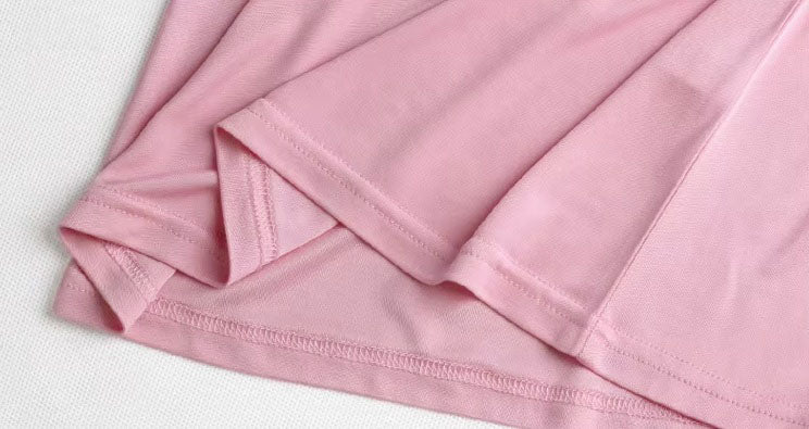 Detailed double-stitching and textured fabric on the bottom of  Women's Silk High-Neck Top in Vanilla Ice, crafted from 100% Mulberry Silk for an elegant foundation to showcase jewelry. From Borcelleclothes.