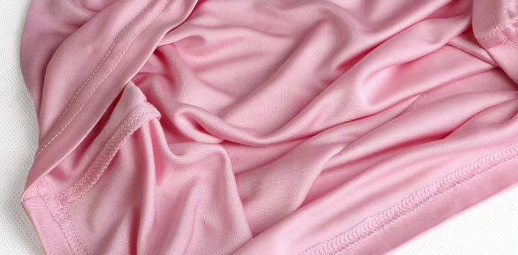 Luxurious draping of a Women's Silk High-Neck Top in Vanilla Ice, crafted from 100% Mulberry Silk for an elegant foundation to showcase jewelry. From Borcelleclothes.