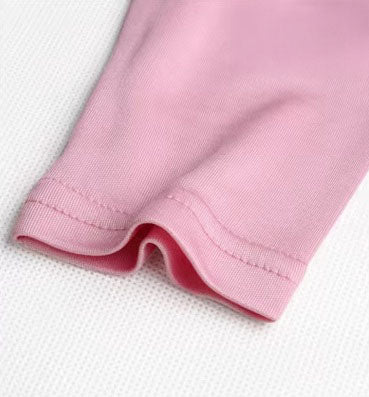 Detailed double-stitching and textured fabric on the end of the sleeve of  Women's Silk High-Neck Top in Vanilla Ice, crafted from 100% Mulberry Silk for an elegant foundation to showcase jewelry. From Borcelleclothes.