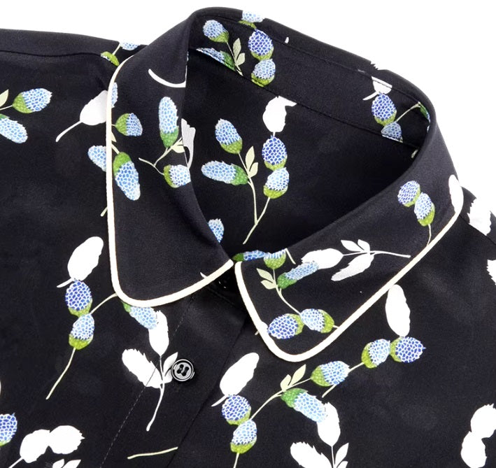 Detailed stitching and textured fabric on the piped collar of a women's silk shirt with berry-inspired print. From Borcelleclothes.
