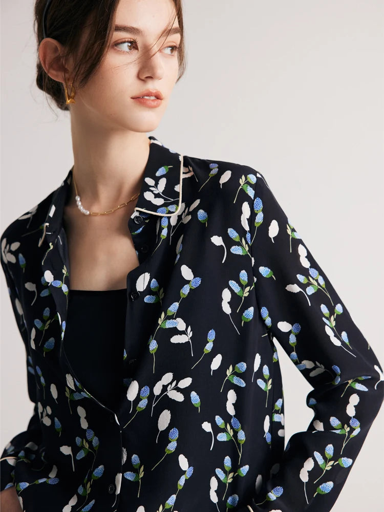 Model looking to the side while wearing a women's silk shirt with berry-inspired print, emphasizing the soft drape and modern design. From Borcelleclothes.